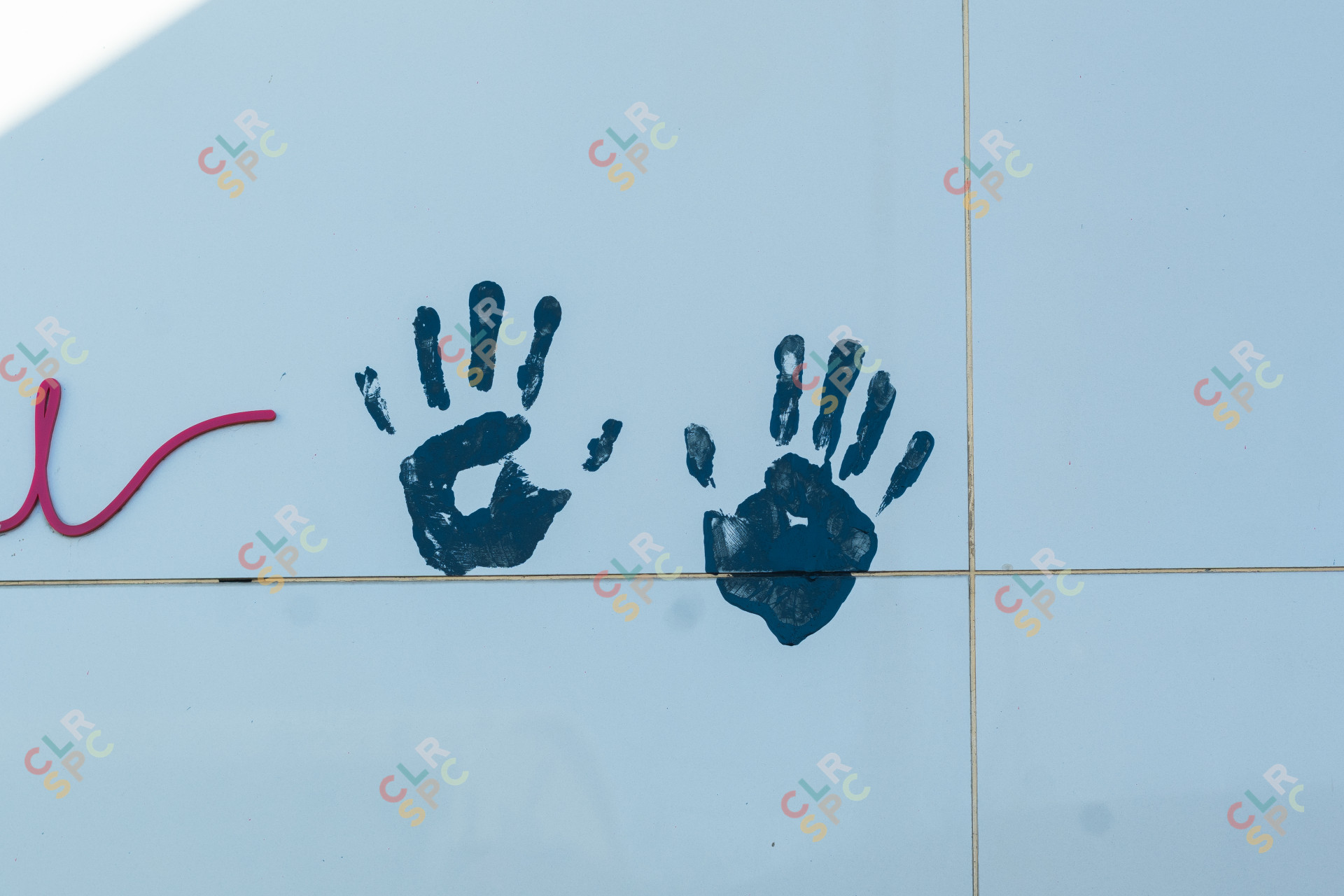 Two baby hand prints on a wall