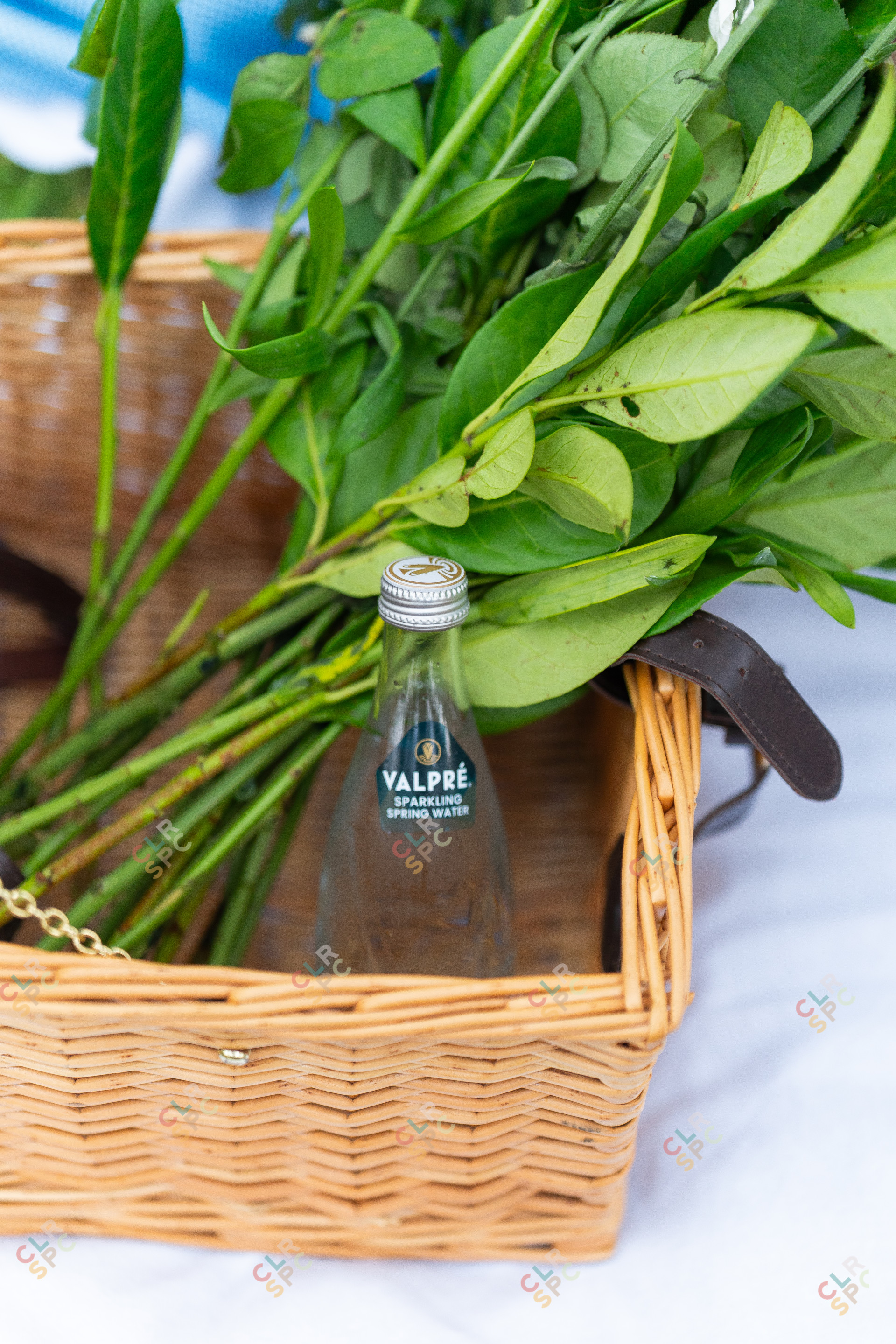 Valpre bottles with flowers in a basket