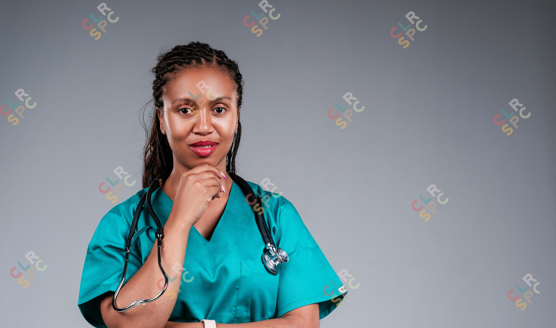 African female doctor confidently posing for the camera with stethoscope.