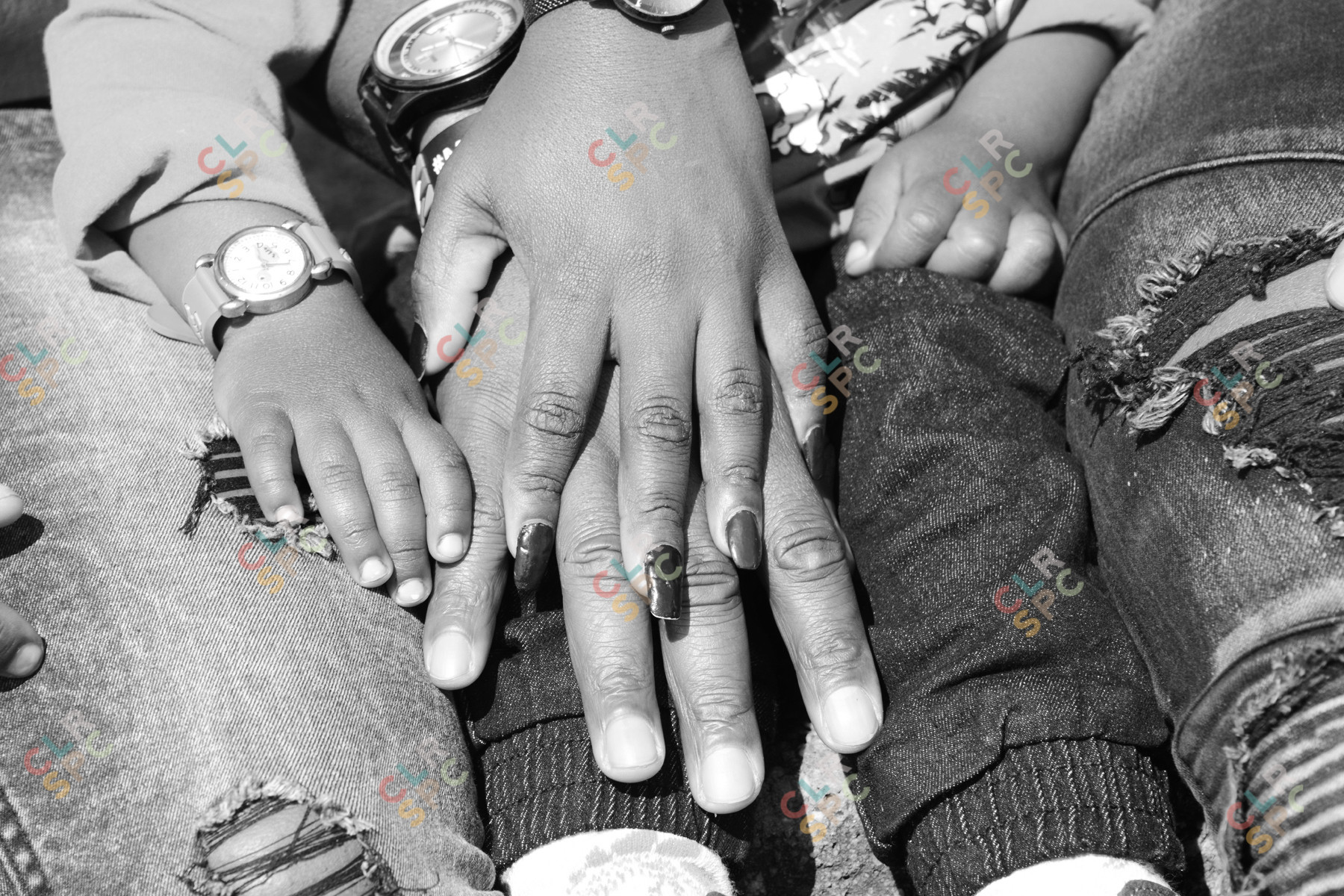 Hands of a mother and son in black and white