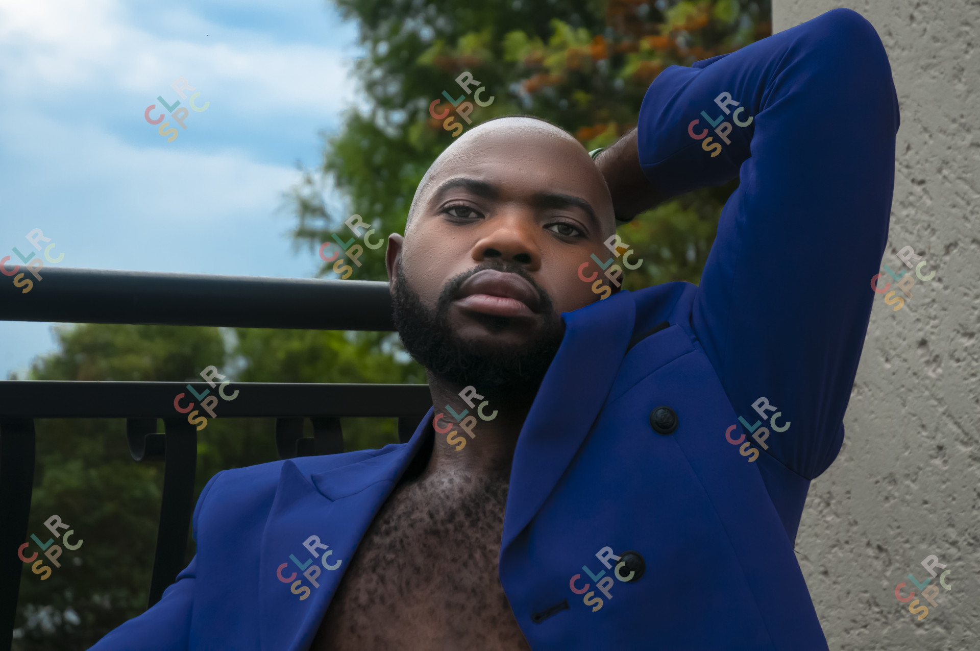 Black male wearing blue coat