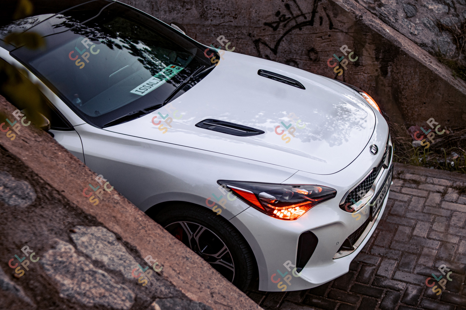 A KIA Stinger under a Bridge