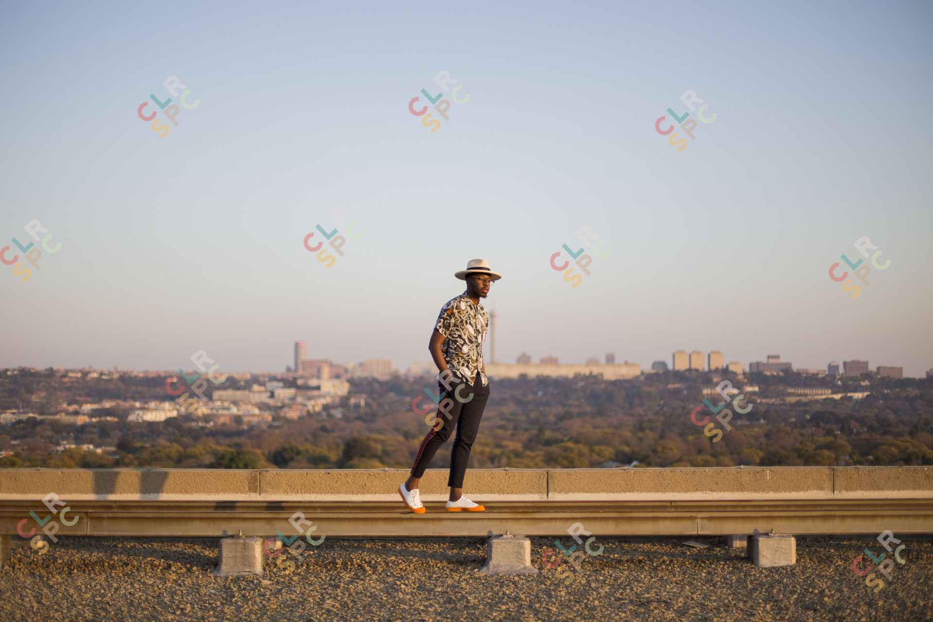 Black man posing in front of joburg skyline