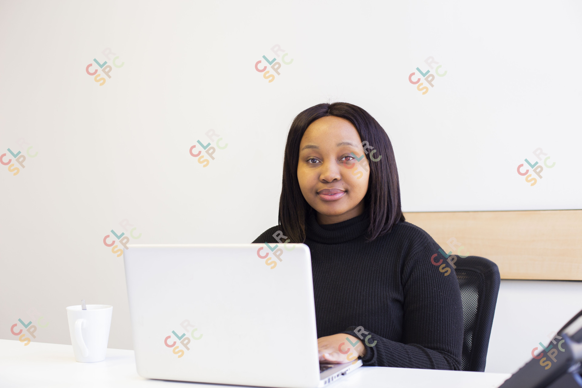 Black corporate woman wearing a mask at the office