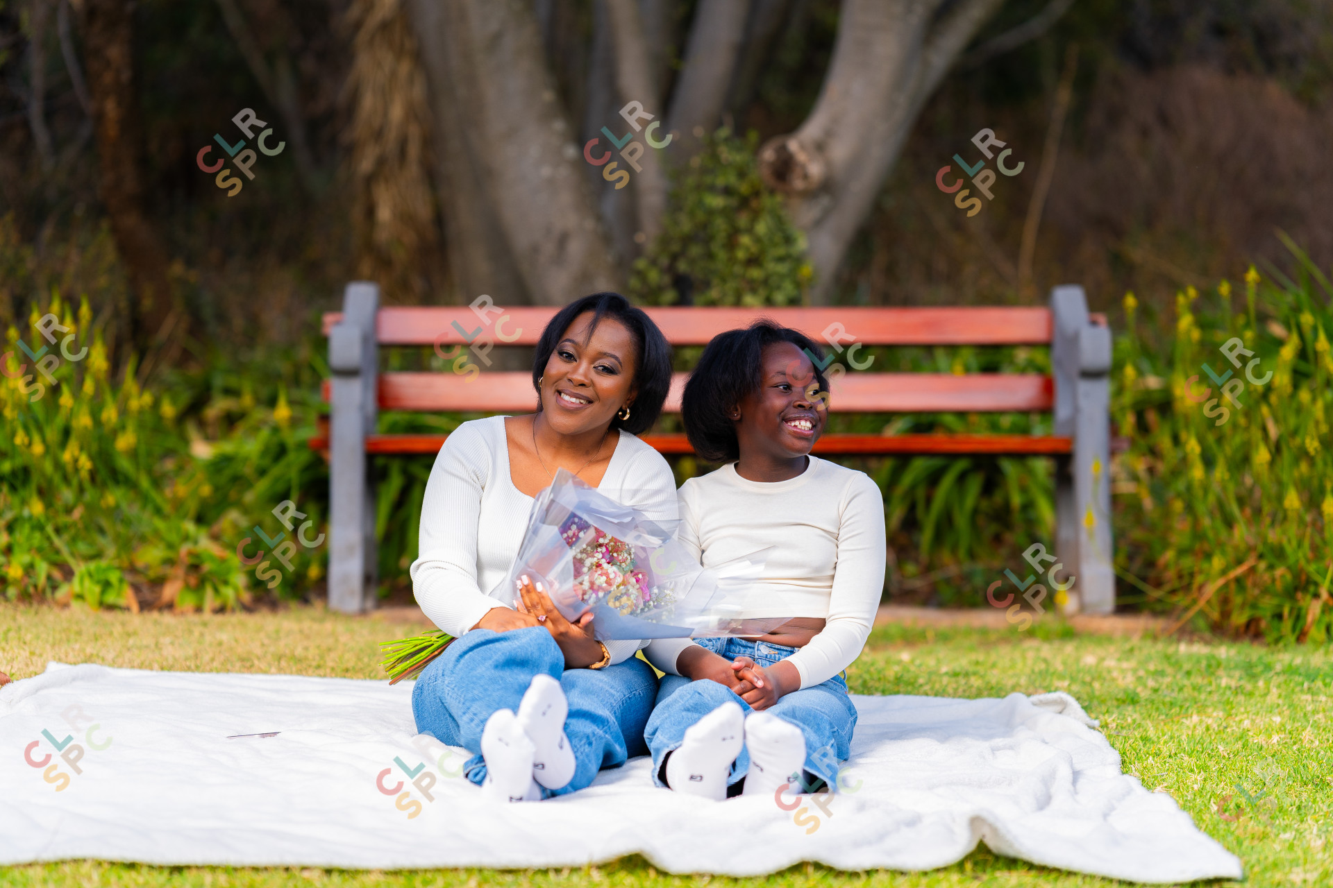 African mother and daughter enjoying a picnic at a park