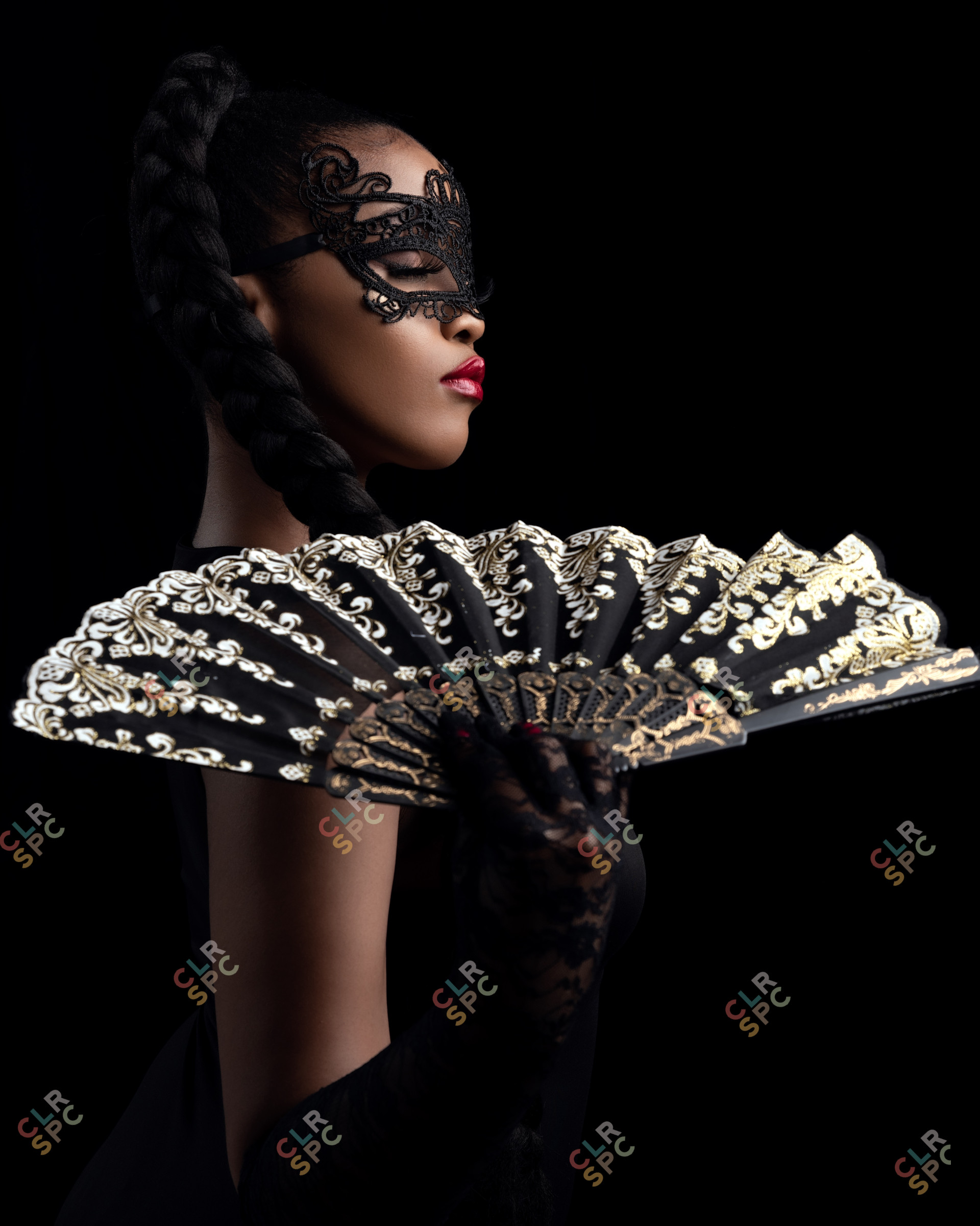 black woman posing in a masquerade mask