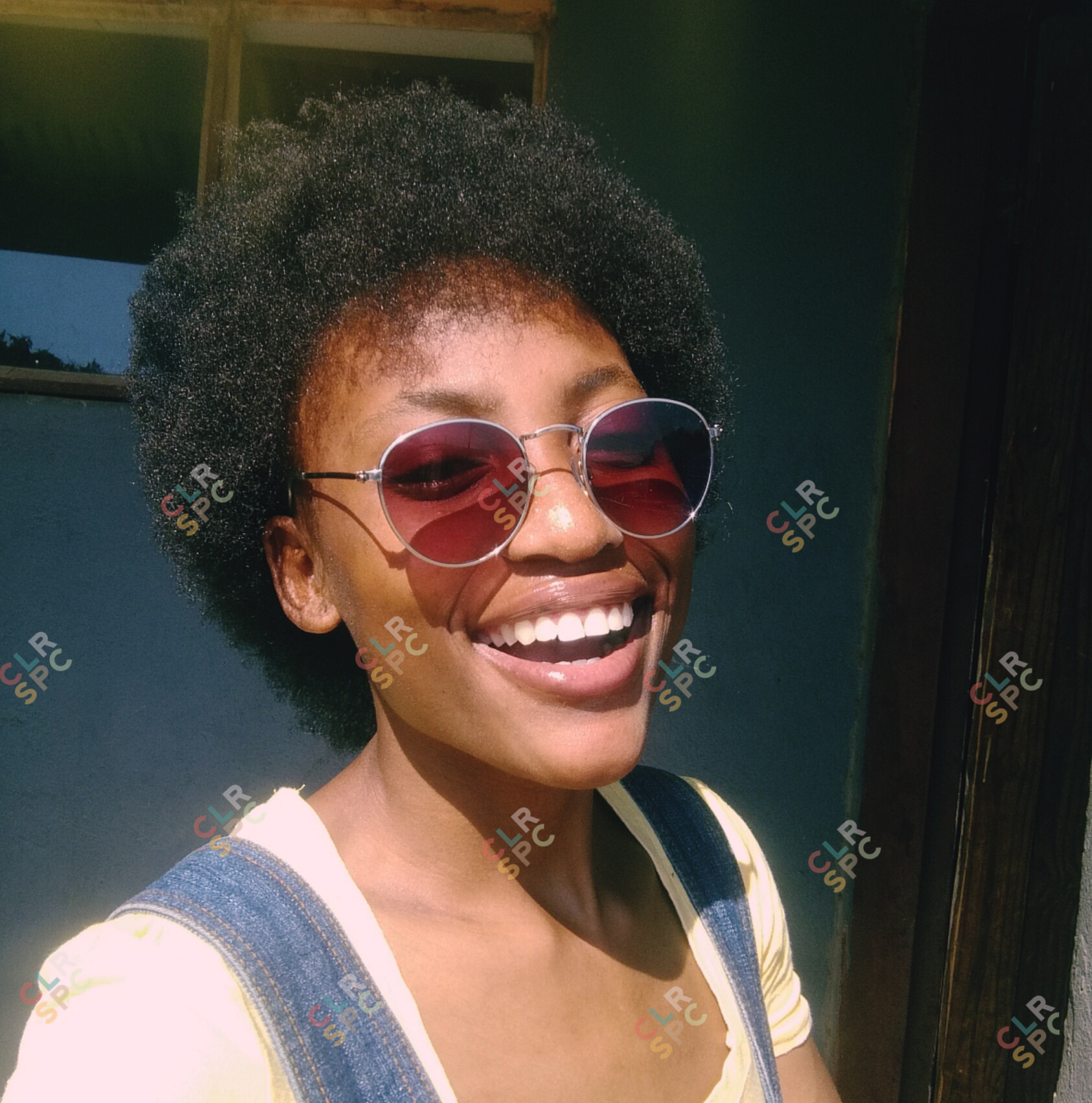 Black woman with afro laughing.