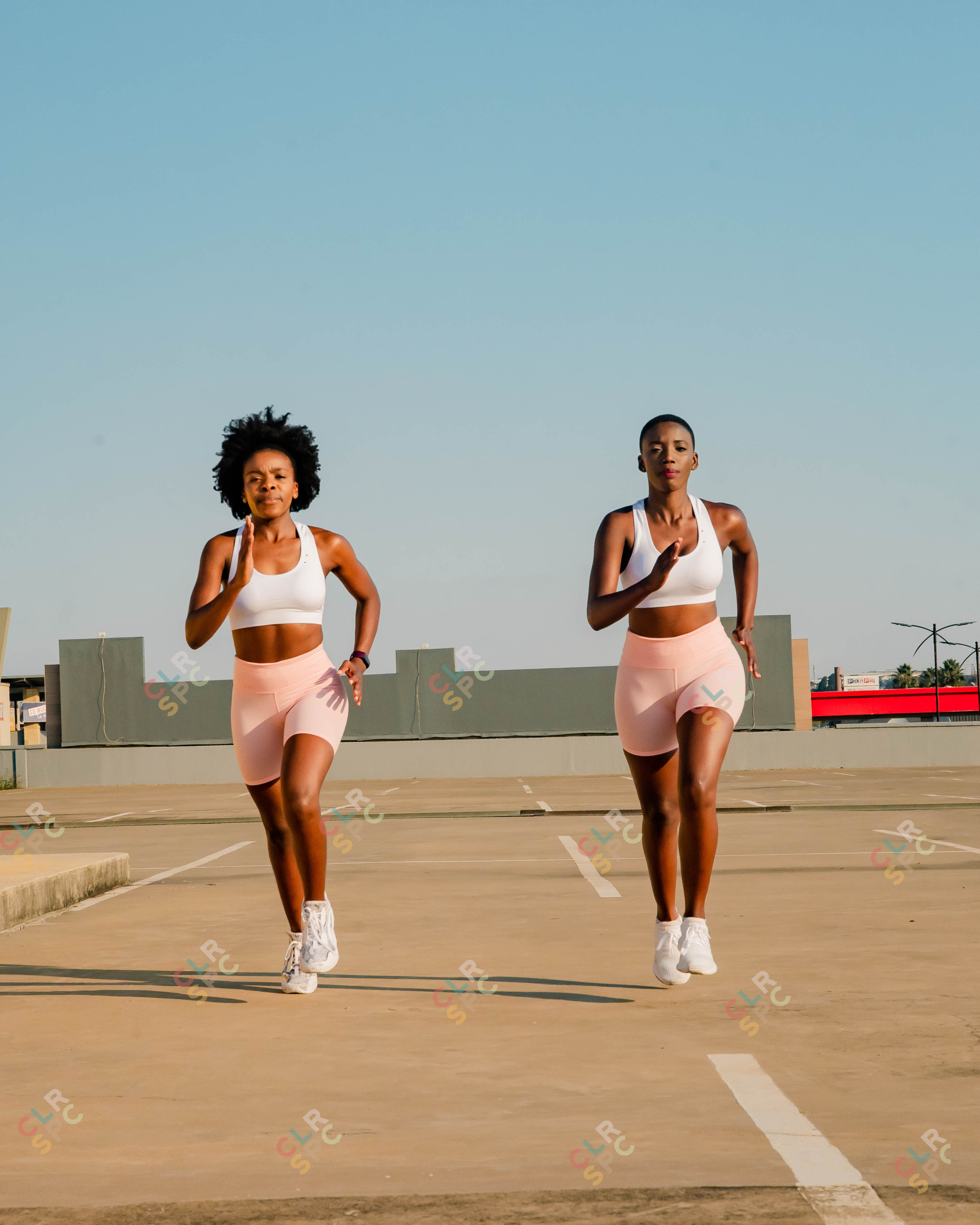 Two black women running on a rooftop