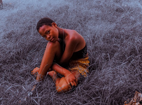 Black girl sitting on grass